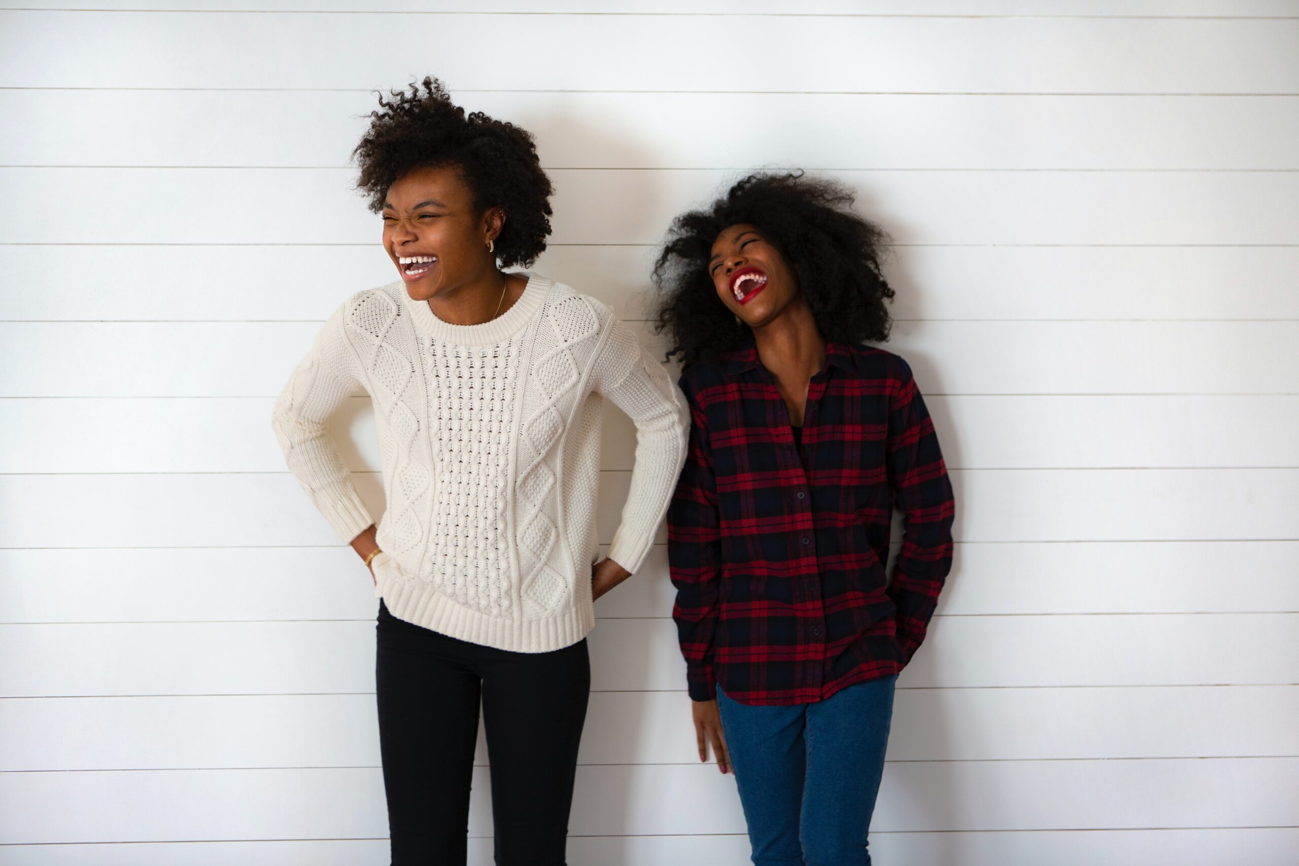 why women need to be financially independent. two black women laughing